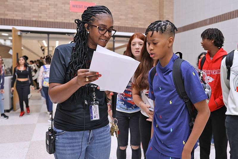 Tanir Gilreath, Langham Creek High School assistant principal, helps a student on the first day of school on Aug. 28. 
